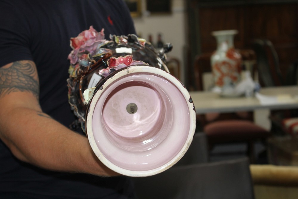 A pair of Italian floral encrusted pottery vases and covers, height 58cm